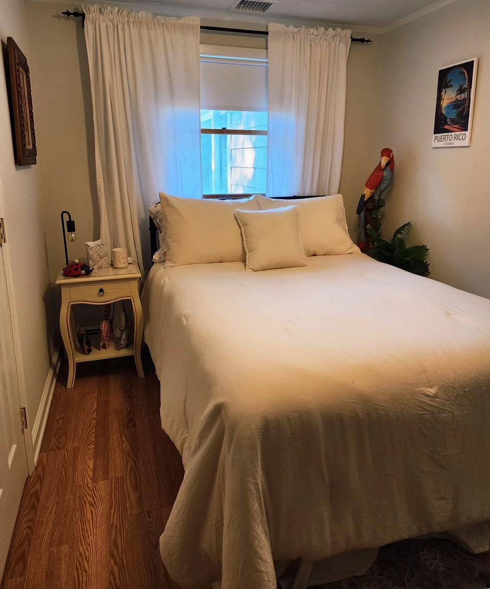 Second bedroom at Cottage 1 with a breezy, tropical feel