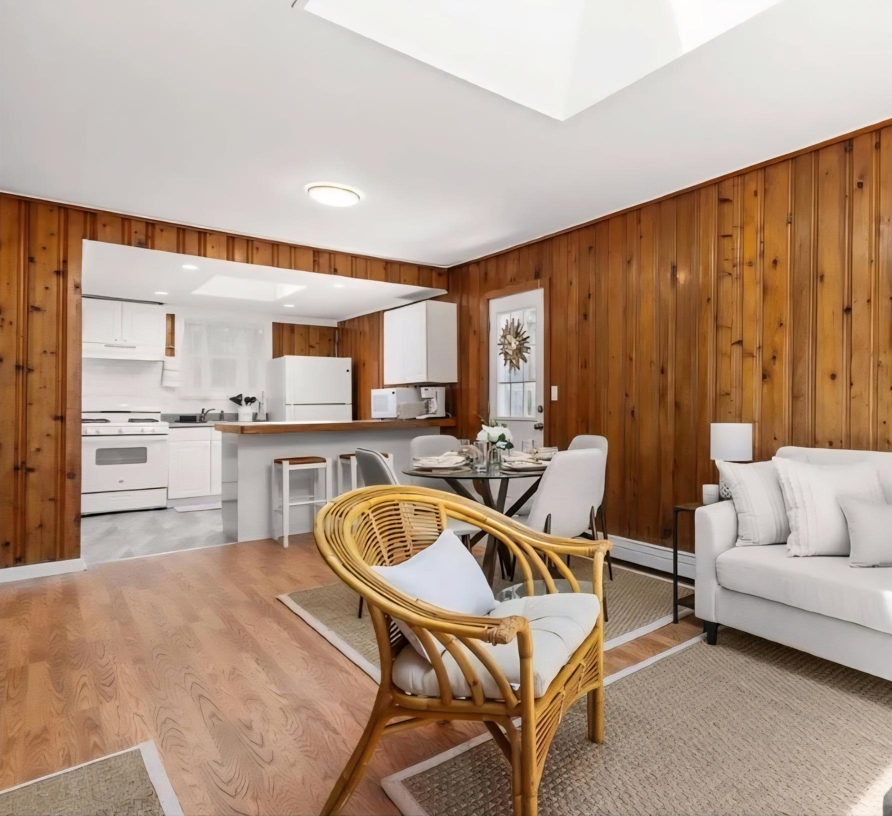 Knotty pine living and dining area at The Classic, with the kitchen beyond