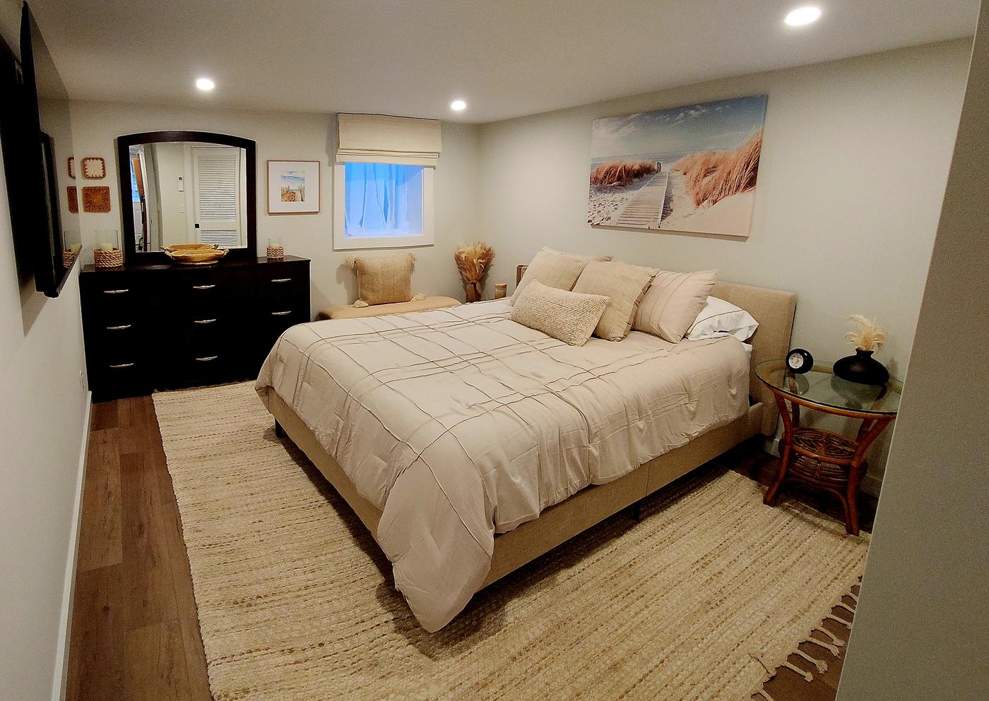 One of the downstairs bedrooms with a beach-inspired palette