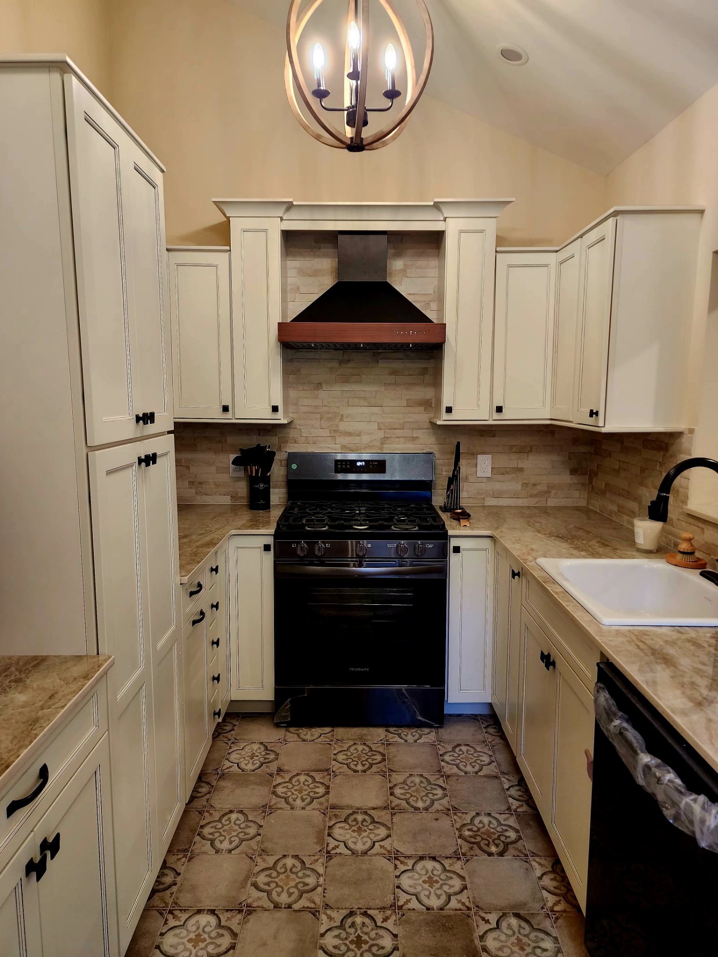 Kitchen with European-style patterned tile floor and wooden chandelier