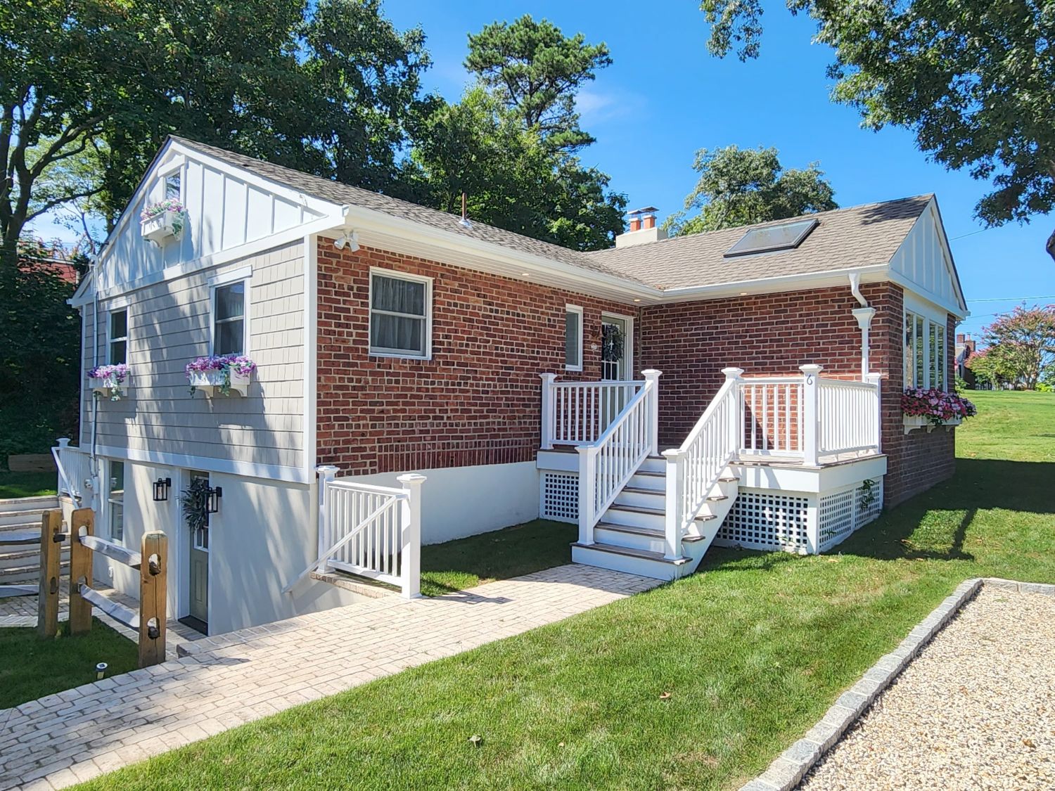 Casa di Rottino, Cottage 6 — brick-and-shingle manor house with white front steps and flower boxes