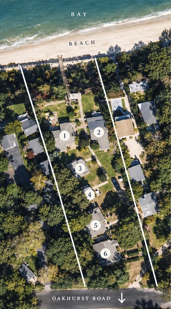 Aerial view of the six numbered cottages between the bay beach and Oakhurst Road
