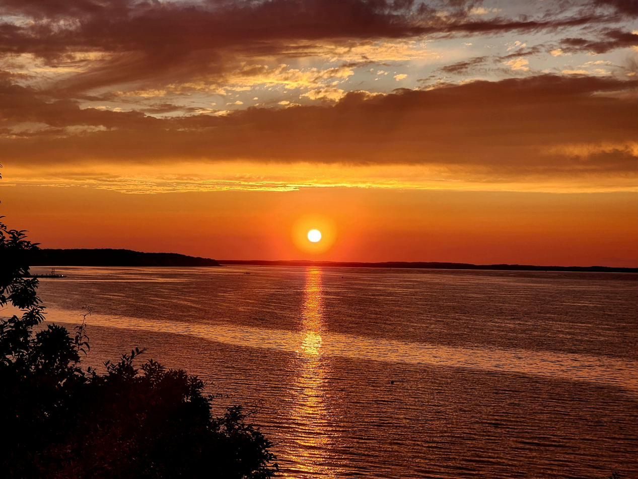 The sun setting in a golden sky over the bay