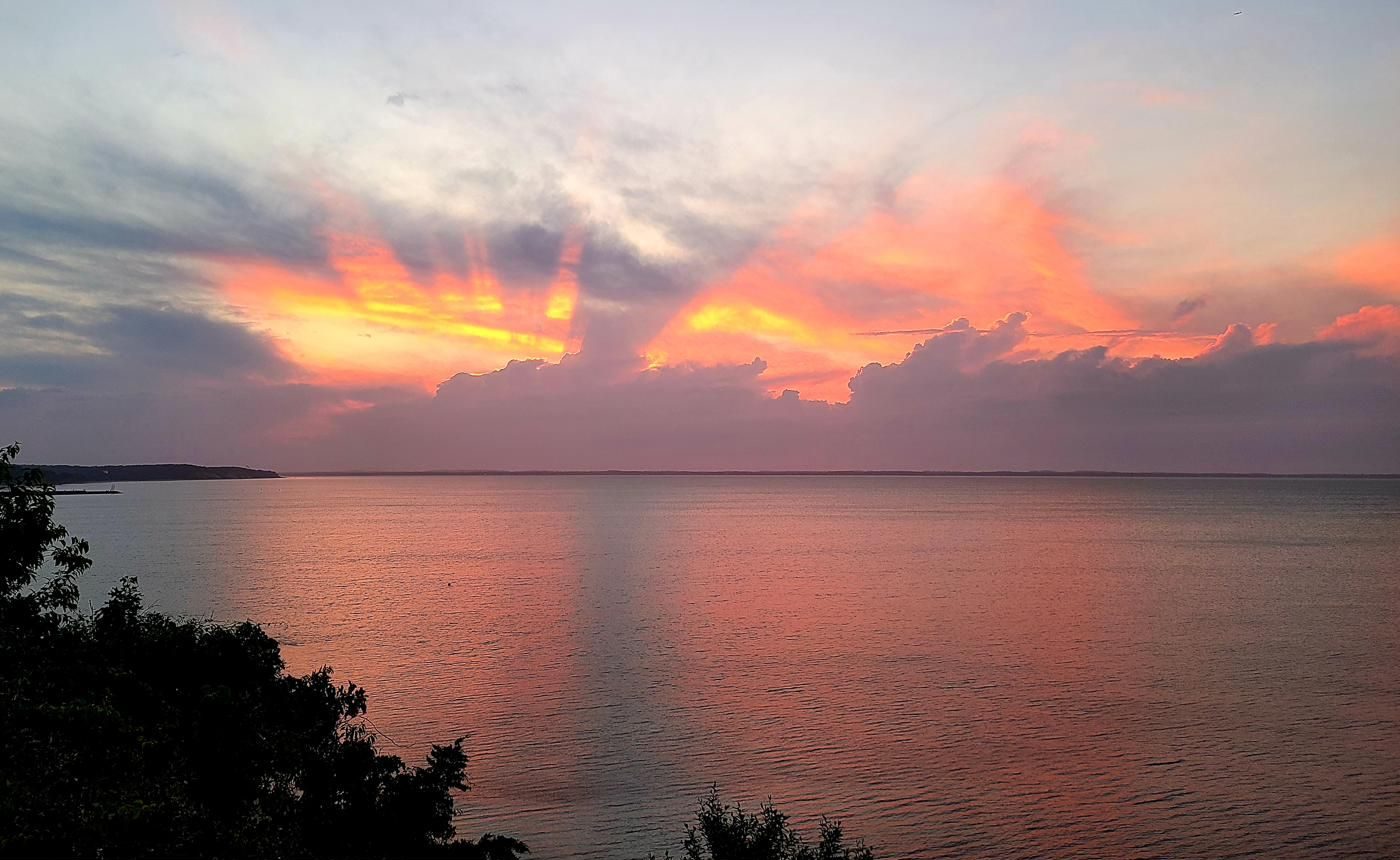 Crepuscular sun rays breaking through clouds at sunset