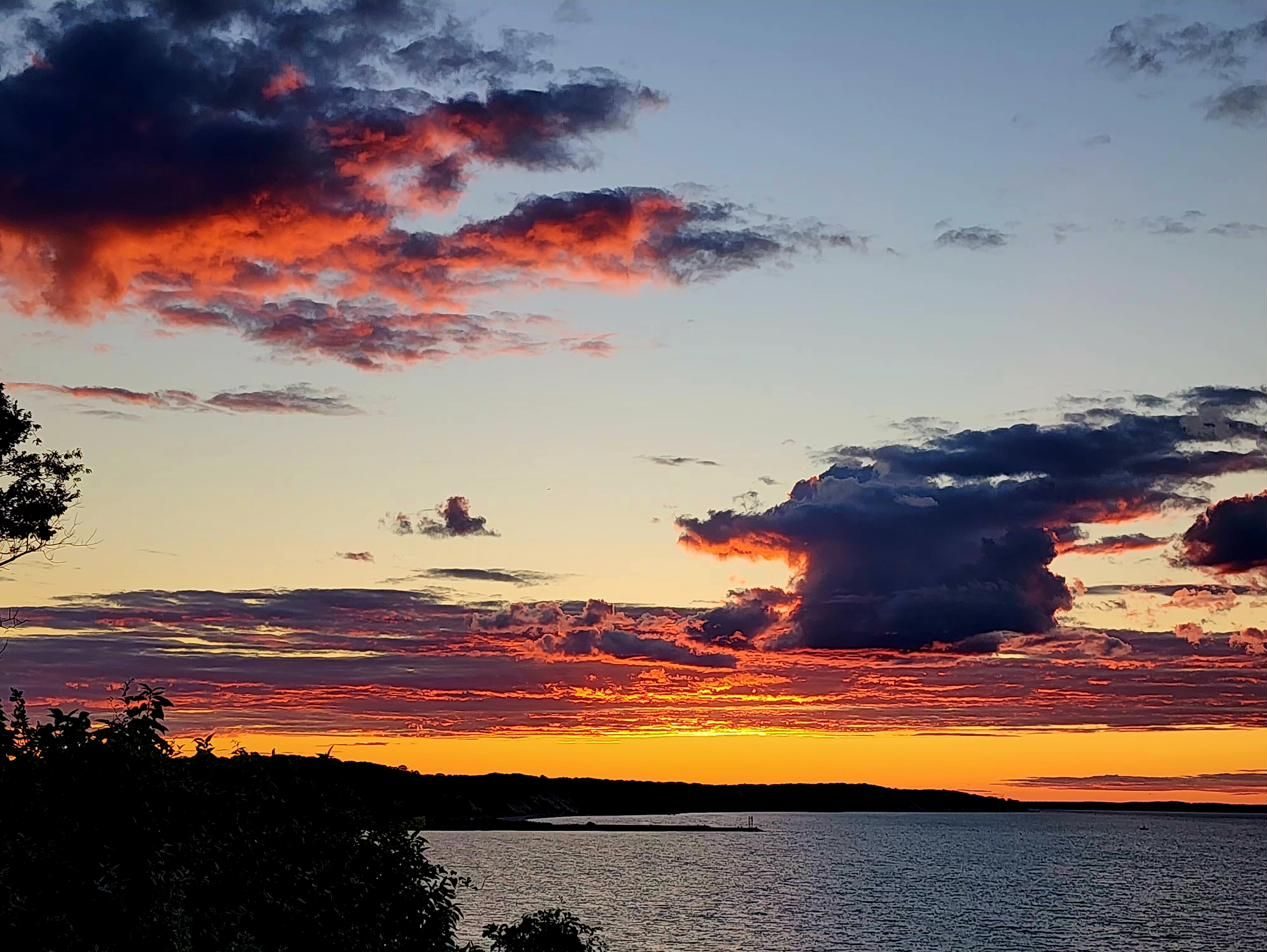 Fiery clouds at sunset over the bay