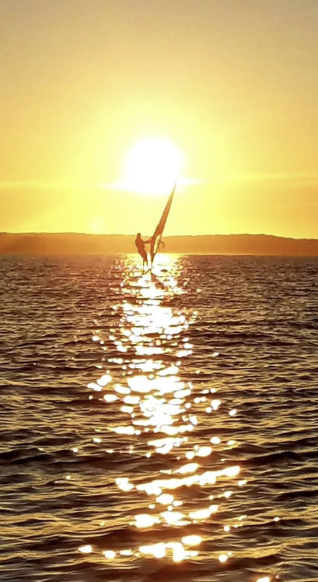 Windsurfer silhouetted against the sunset on Peconic Bay